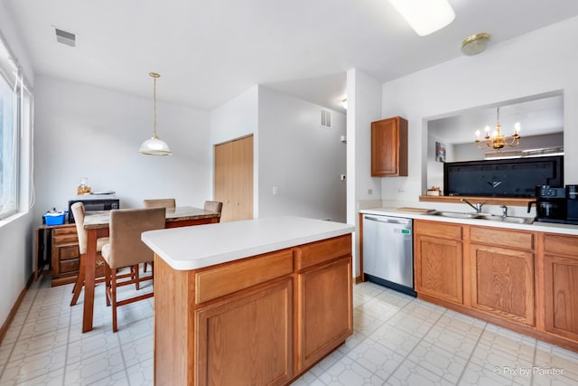 kitchen featuring sink, stainless steel dishwasher, a chandelier, decorative light fixtures, and a kitchen island