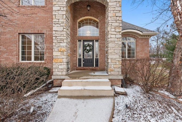 view of snow covered property entrance