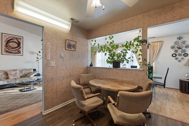 dining space featuring hardwood / wood-style flooring and ceiling fan