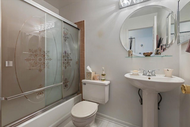 full bathroom with sink, bath / shower combo with glass door, and toilet