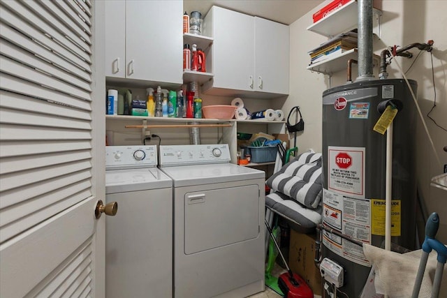 laundry room featuring cabinets, independent washer and dryer, and water heater