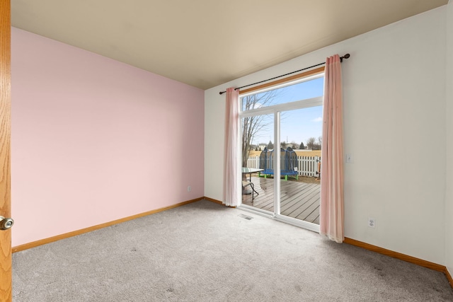 unfurnished room with visible vents, baseboards, and carpet flooring