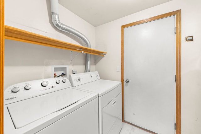 washroom featuring laundry area, washing machine and dryer, and marble finish floor