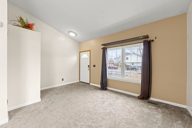 interior space with visible vents, baseboards, and vaulted ceiling