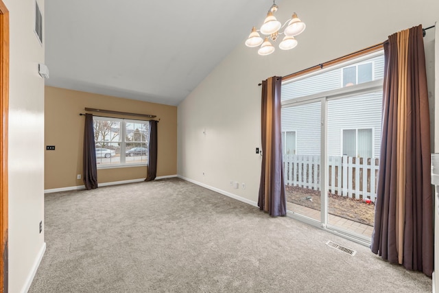 unfurnished room featuring visible vents, a chandelier, and carpet flooring