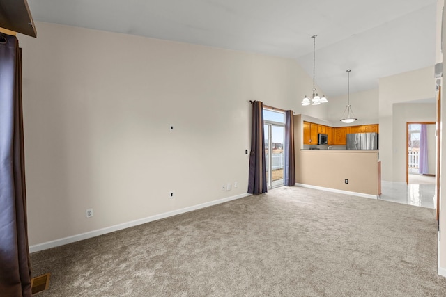 unfurnished living room with a notable chandelier, visible vents, carpet flooring, high vaulted ceiling, and baseboards