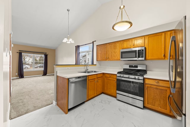 kitchen featuring appliances with stainless steel finishes, marble finish floor, a healthy amount of sunlight, and a sink