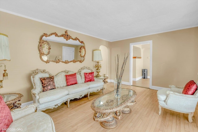 living room with ornamental molding and wood-type flooring