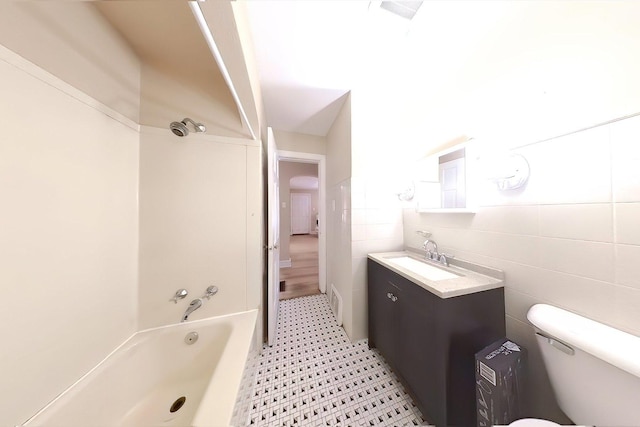 full bathroom featuring vanity, shower / bathing tub combination, tile walls, and toilet