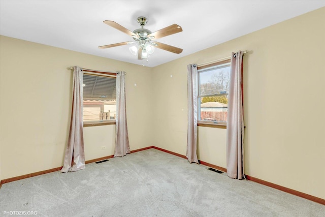 empty room featuring light colored carpet and ceiling fan