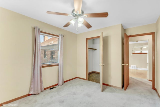 unfurnished bedroom with light carpet and ceiling fan