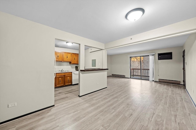 kitchen featuring a baseboard radiator, light hardwood / wood-style flooring, dishwasher, sink, and a wall mounted air conditioner