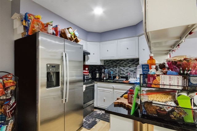 kitchen with tasteful backsplash, sink, white cabinetry, light hardwood / wood-style flooring, and appliances with stainless steel finishes