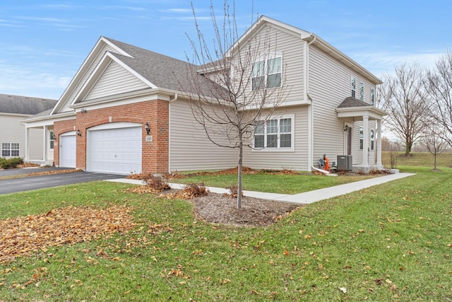 view of front facade featuring central air condition unit, a front yard, and a garage