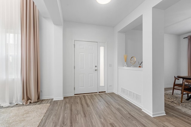 foyer featuring plenty of natural light and light hardwood / wood-style floors