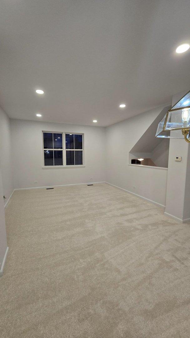 basement featuring light carpet