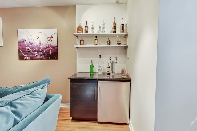 bar featuring light hardwood / wood-style floors