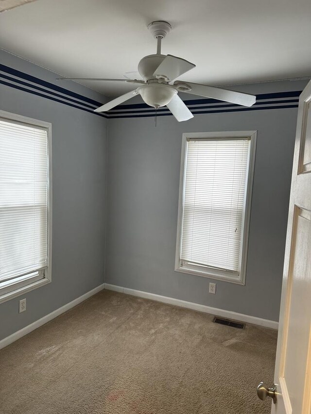 unfurnished room featuring carpet and ceiling fan