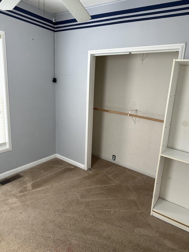 interior space with a closet and carpet flooring