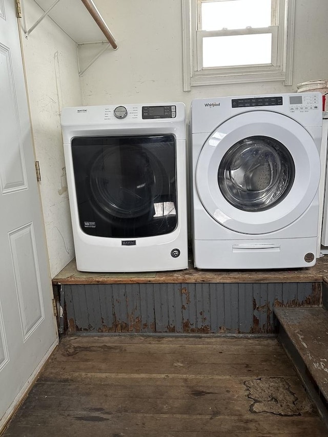 washroom with dark hardwood / wood-style floors and washing machine and clothes dryer