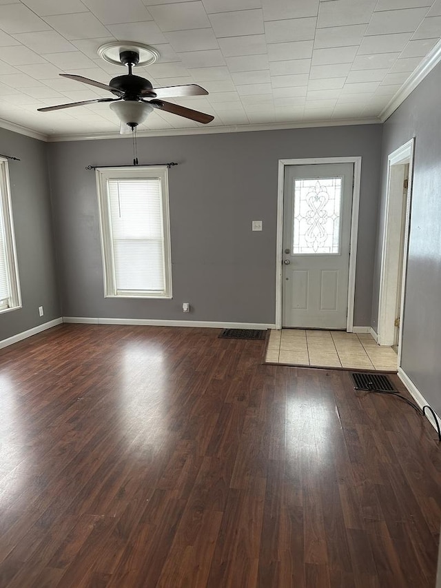 foyer with ceiling fan, ornamental molding, and light wood-type flooring