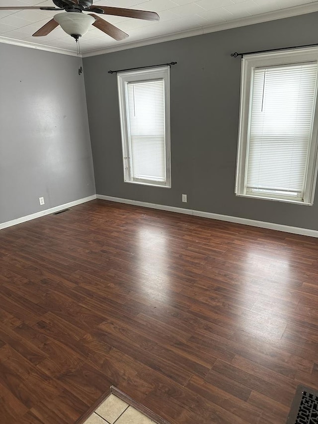 unfurnished room with ceiling fan, dark hardwood / wood-style floors, and ornamental molding