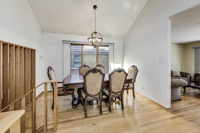 dining space featuring a notable chandelier, light wood-type flooring, and lofted ceiling