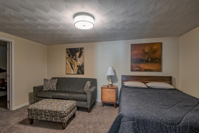 bedroom with a textured ceiling and light colored carpet