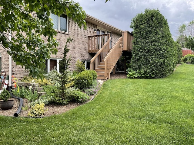 back of house with a wooden deck and a lawn