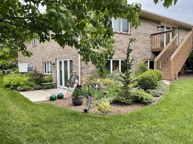 rear view of house with a yard and a patio area