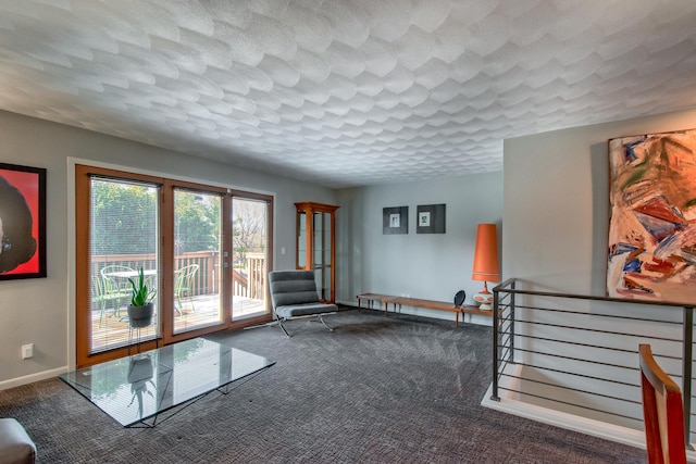 unfurnished room featuring a textured ceiling and dark carpet