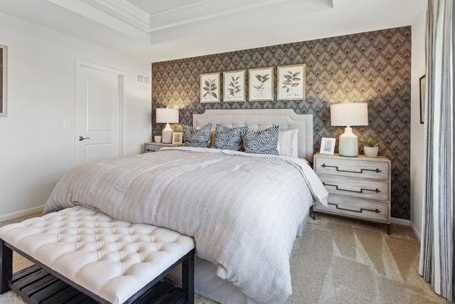 carpeted bedroom featuring a tray ceiling