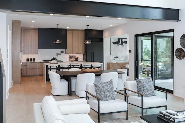 kitchen with pendant lighting, light hardwood / wood-style flooring, tasteful backsplash, beamed ceiling, and extractor fan