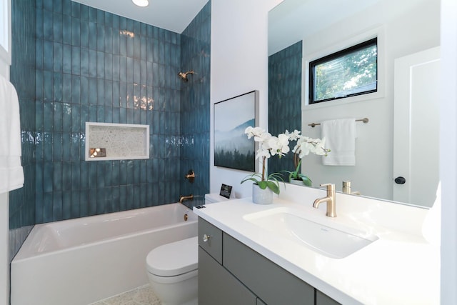 full bathroom with vanity, tiled shower / bath combo, toilet, and tile patterned flooring