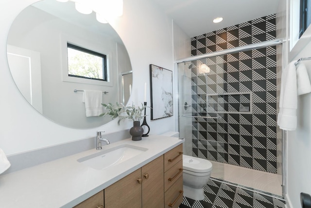 bathroom featuring vanity, toilet, and walk in shower