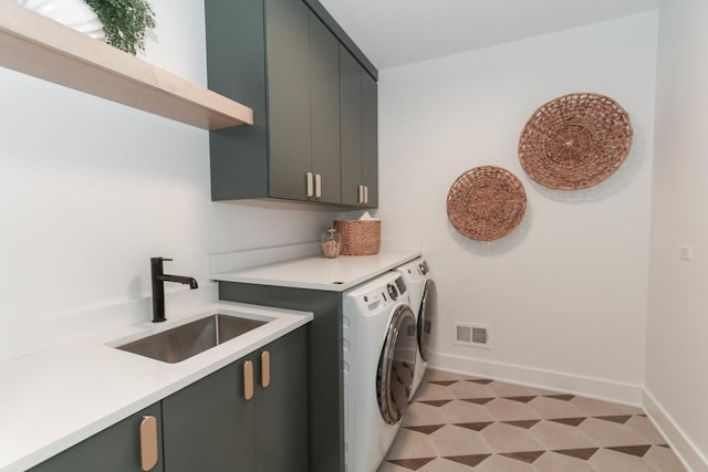 washroom featuring cabinets, separate washer and dryer, and sink