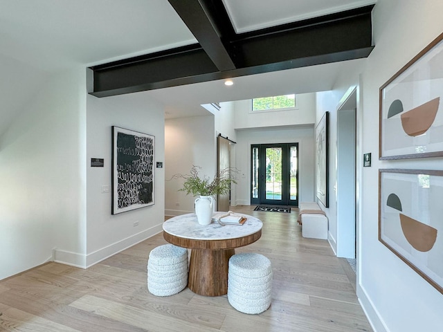 hall with beam ceiling and light hardwood / wood-style flooring