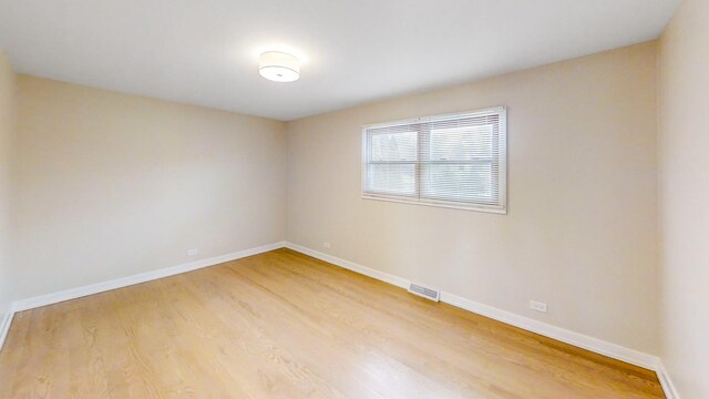 empty room with hardwood / wood-style flooring