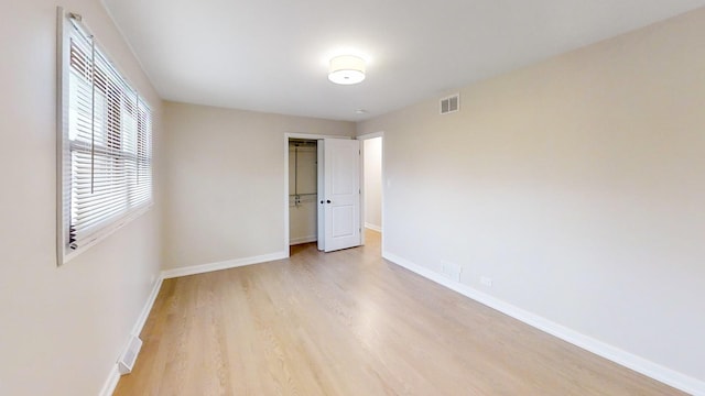 unfurnished bedroom featuring a closet and light hardwood / wood-style flooring