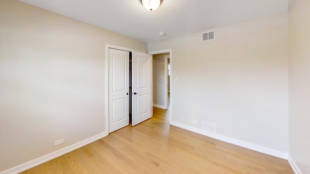 unfurnished room with light wood-type flooring