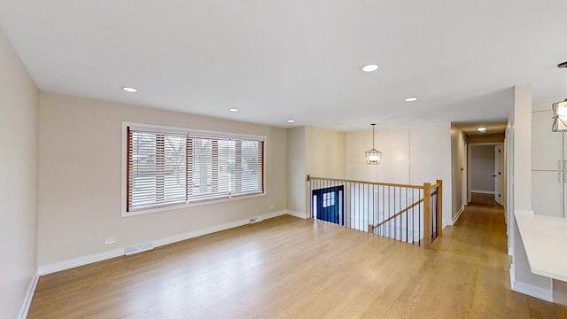 unfurnished room with wood-type flooring