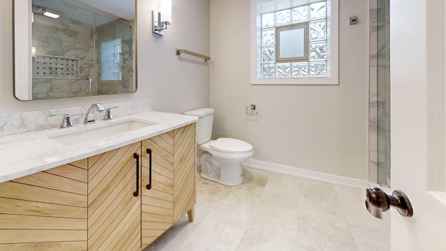 bathroom featuring toilet, a shower with door, and vanity