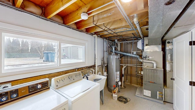 laundry room featuring sink, washer and clothes dryer, and gas water heater