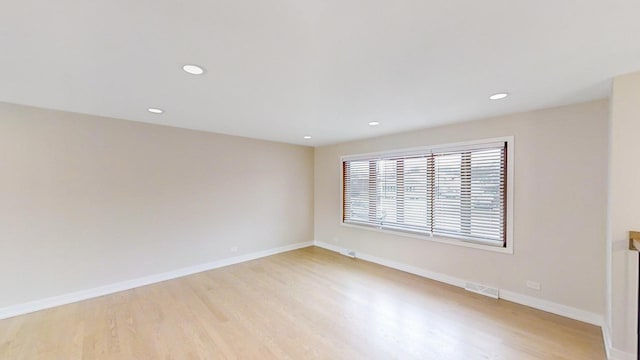 spare room featuring light hardwood / wood-style floors