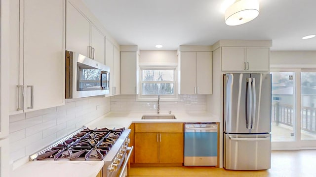 kitchen featuring sink, decorative backsplash, and stainless steel appliances