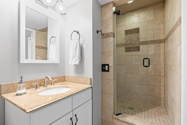 bathroom featuring vanity and an enclosed shower