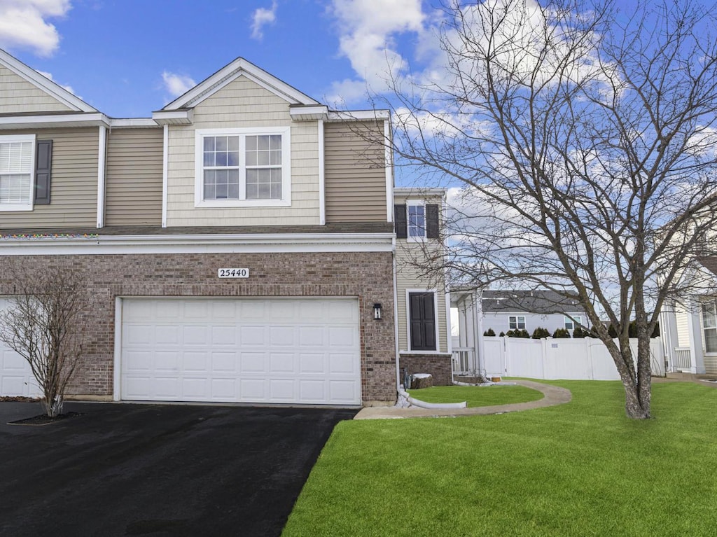 view of front of home featuring a front yard and a garage