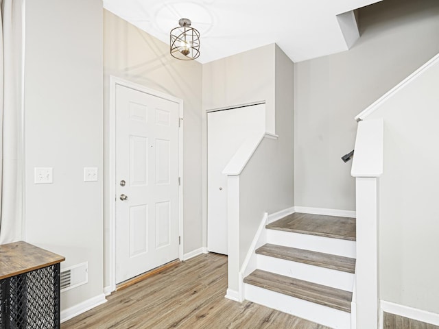 foyer featuring an inviting chandelier and hardwood / wood-style flooring