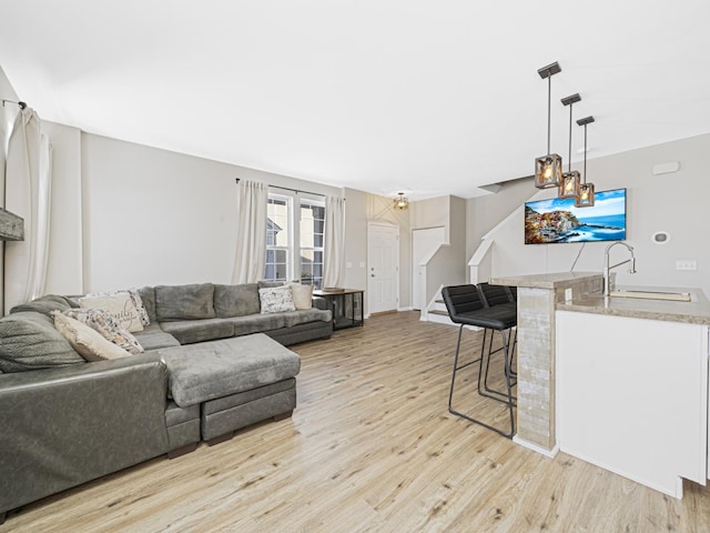 living room with sink and light wood-type flooring