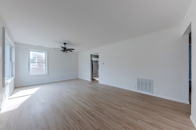 unfurnished room with ceiling fan, light wood-type flooring, and ornamental molding